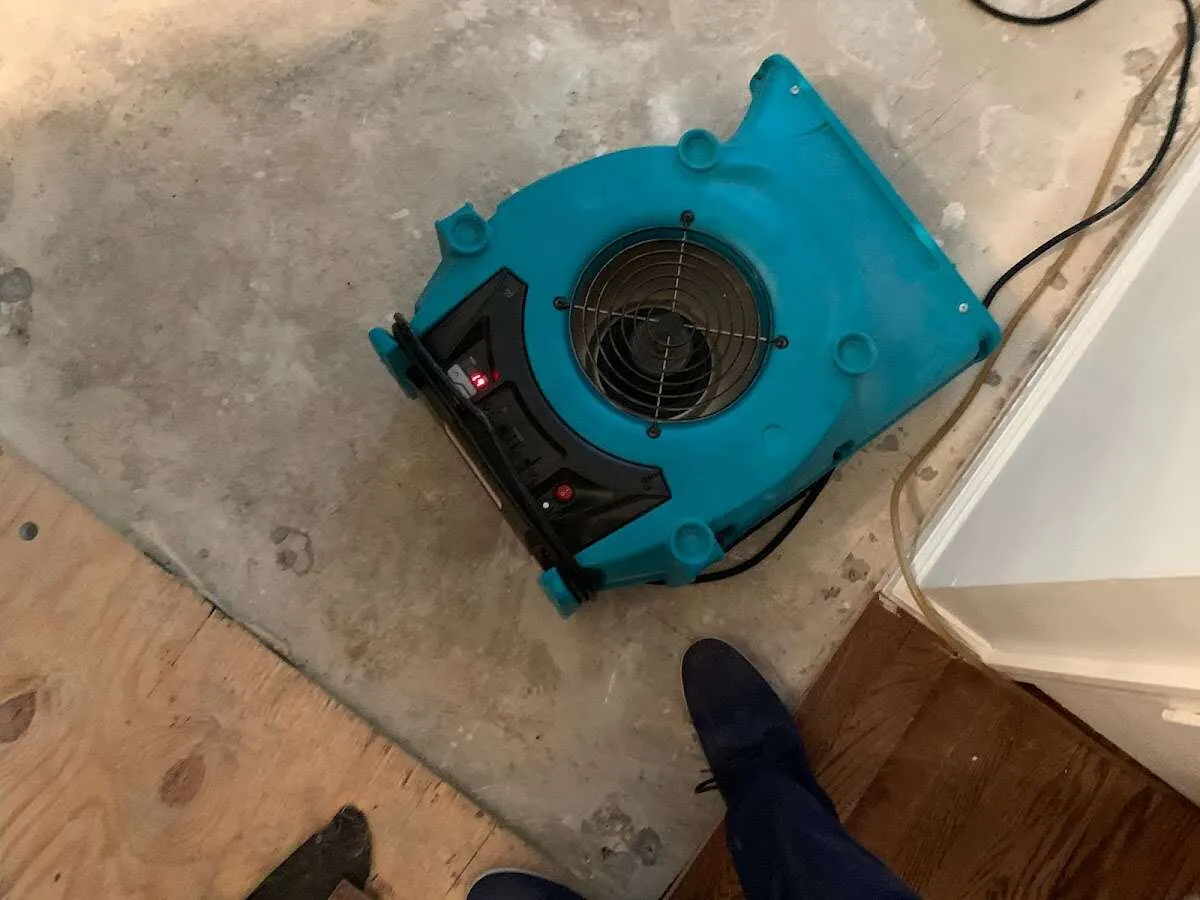Air mover drying subfloor during Leak Detection & Repair in Oakwood